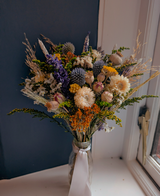 Enchanted Forest posy in milk bottle