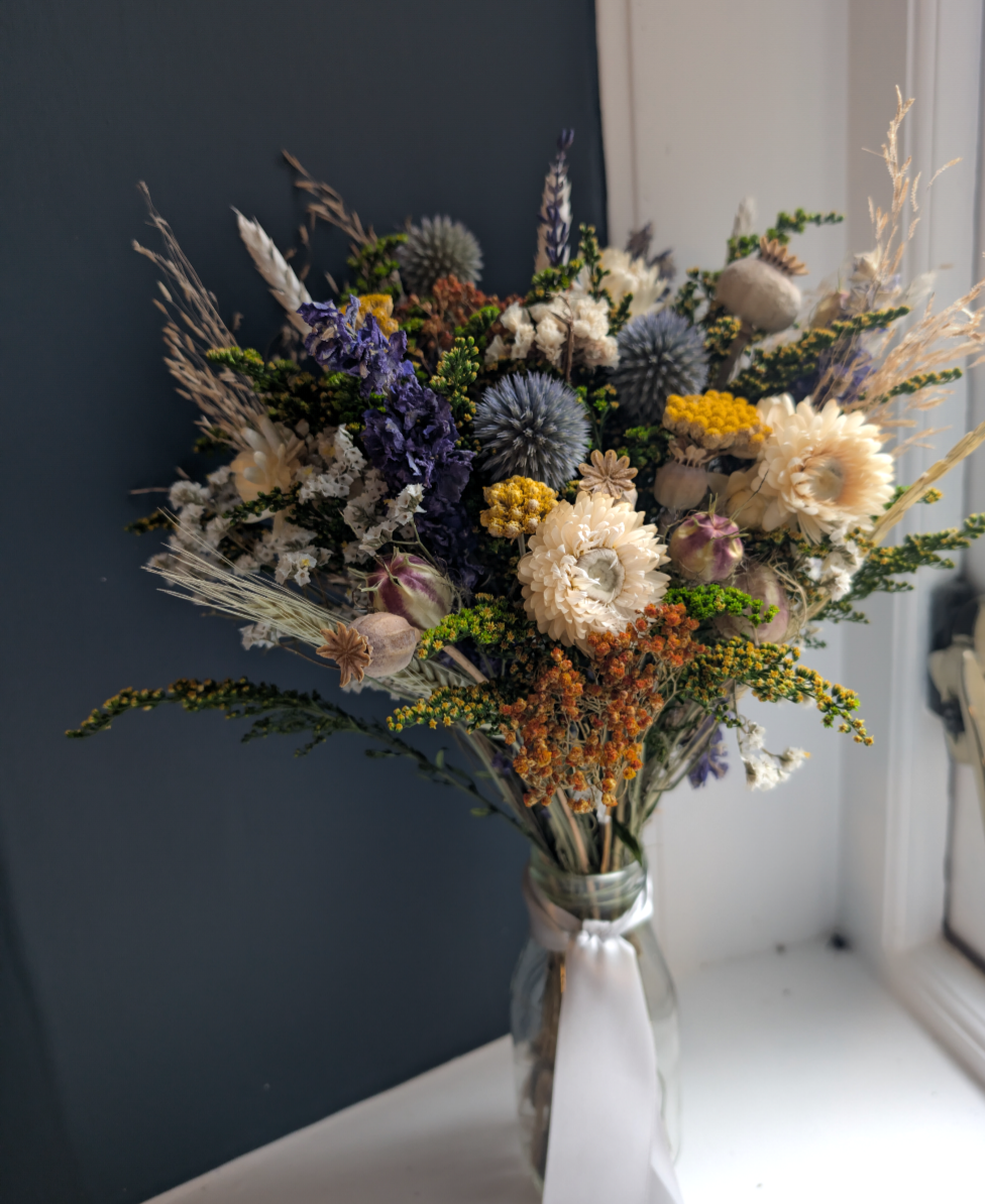 Enchanted Forest posy in milk bottle